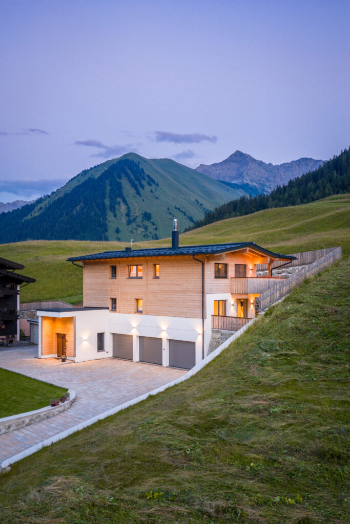 Referenz Holzbau Saurer Wohnbau Einfamilienhaus Außenaufnahme Holzfassade Hanglage Bergpanorama